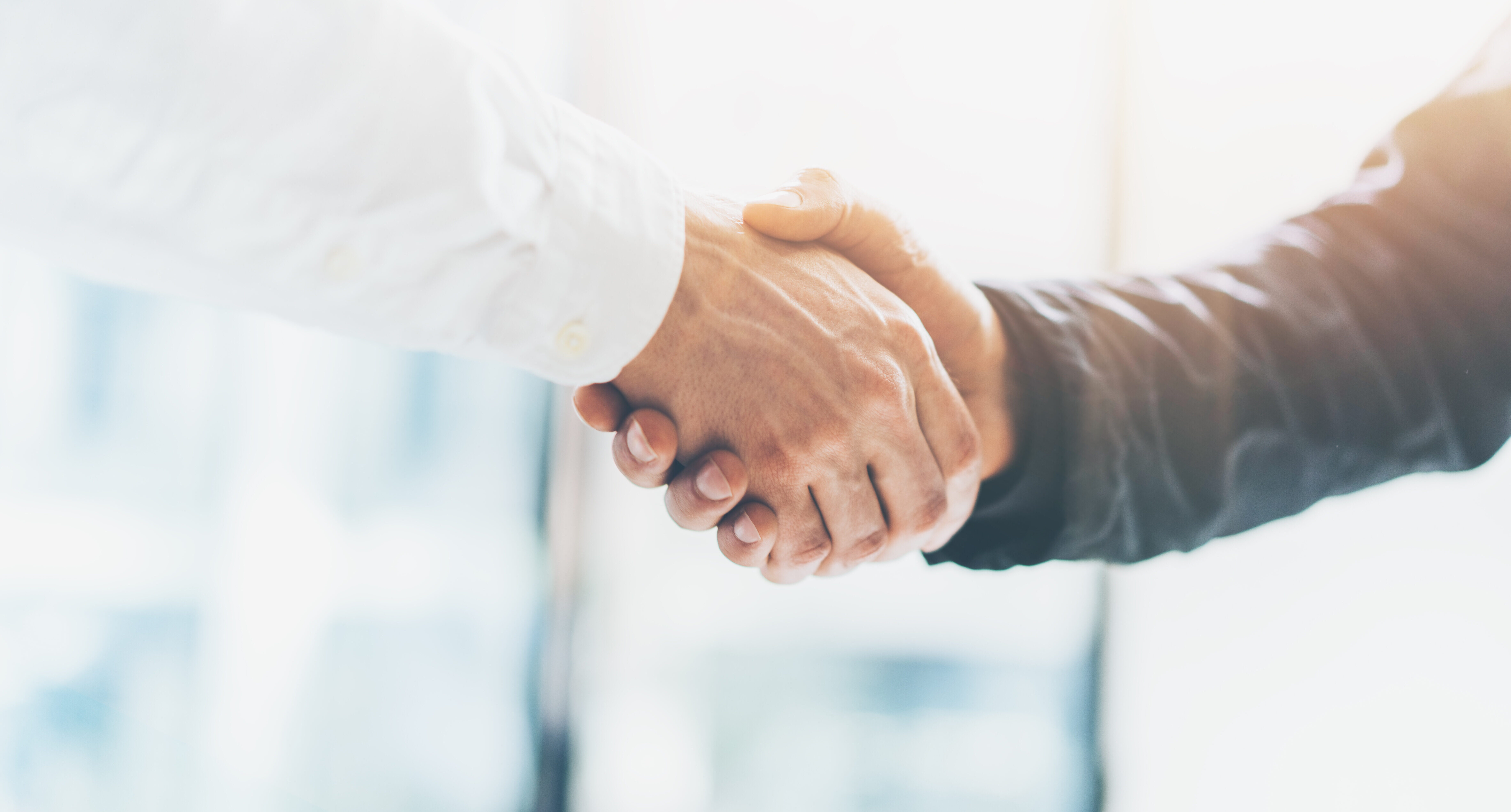 Business partnership meeting. Picture businessmans handshake. Successful businessmen handshaking after good deal. Horizontal, blurred background